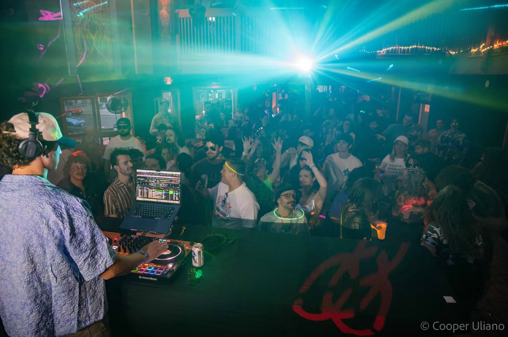 Crowd gathered around the DJ booth during a J3RD set